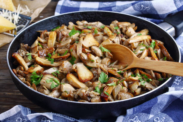 fried porcini with parsley in skillet