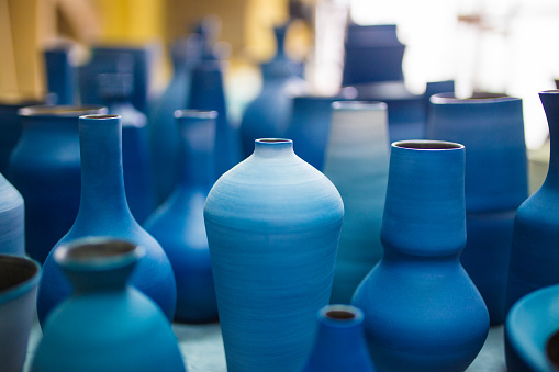 Handmade vintage ceramic tableware according to medieval technologies, isolated on a white background. Reconstruction of the events of the Middle Ages in Europe.