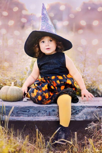istock Little girl in halloween witch costume. 858701574
