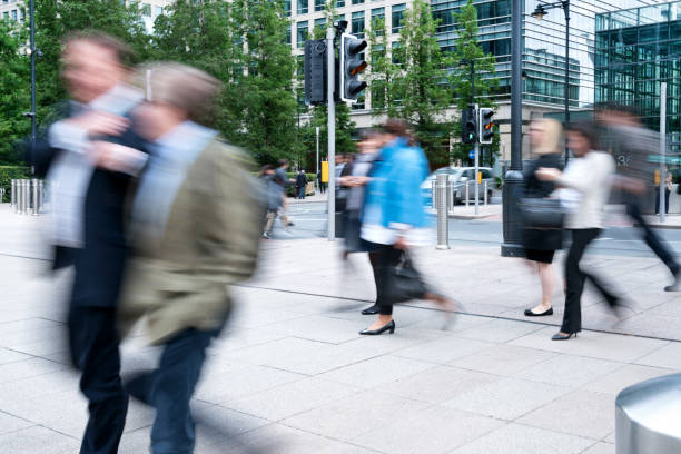 istock Blurred People walking in front of Modern Office Buildings 858701820