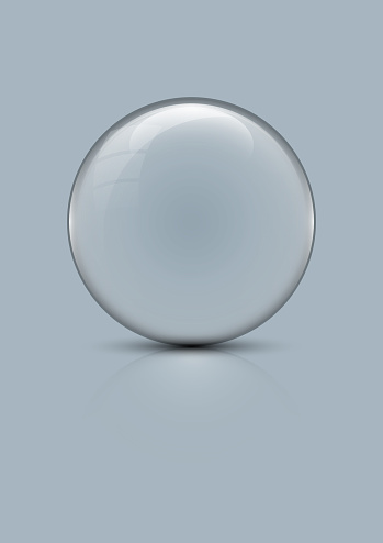 Transparent glass ball against clear silver colored background