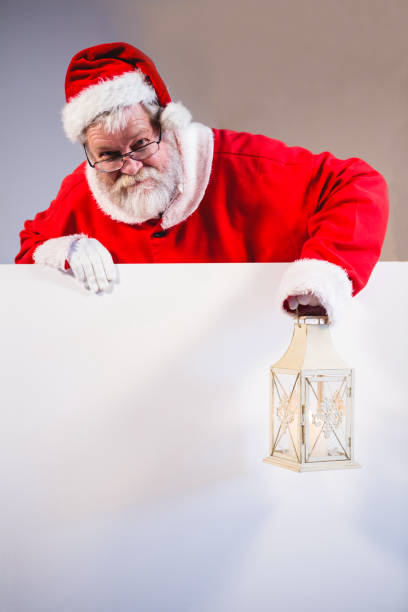 istock Santa claus holding christmas lantern 858702608