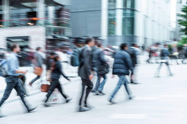 istock Blurred People walking in front of Modern Office Buildings 858703028