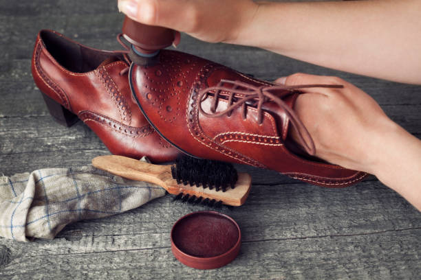 istock Cobbler applying shoe shiner on shoe 858706936