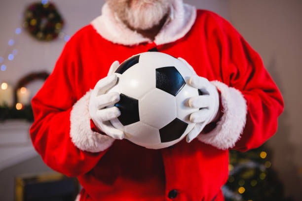 istock Santa claus holding a football 858707030