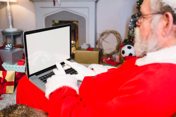 istock Santa claus sitting and using laptop 858708340