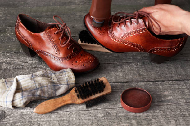 istock Shoemaker applying shoe shiner on shoe 858711396