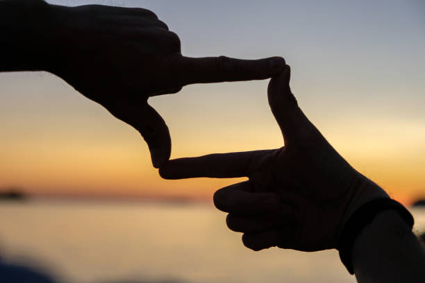 istock Silhouette finger frame of sunset in Croatia 858718360