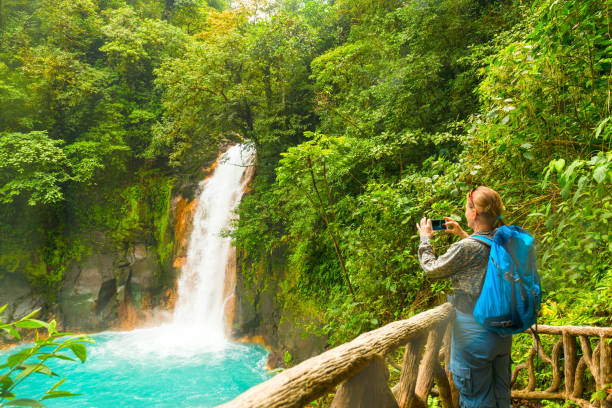 istock Woman photographing the river 858719108