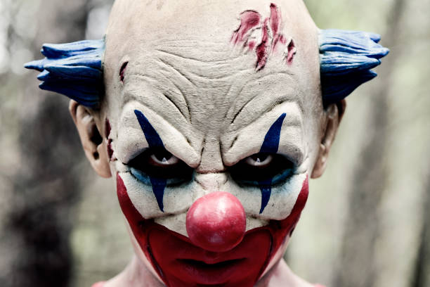 istock scary evil clown in the woods 858719160