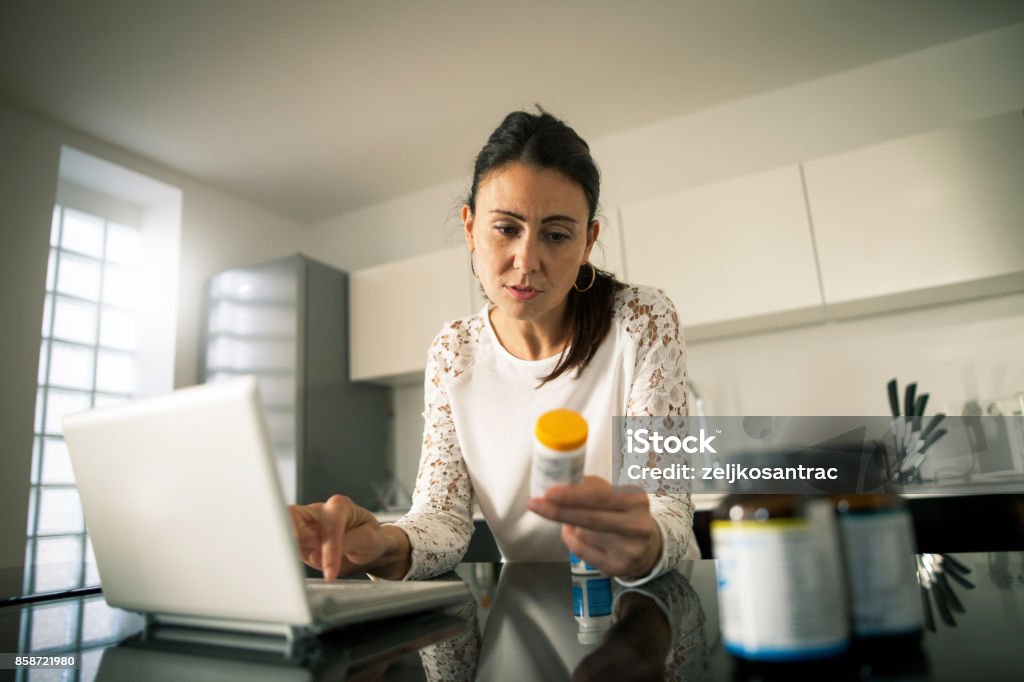 Filling prescription online Woman Searching Medicine Prescription Medicine Stock Photo