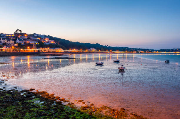 Coastline of Saint Aubin Jersey at low tide and sunset Coastline of Saint Aubin, Jersey, Channel Islands, UK at low tide and sunset. channel islands england stock pictures, royalty-free photos & images