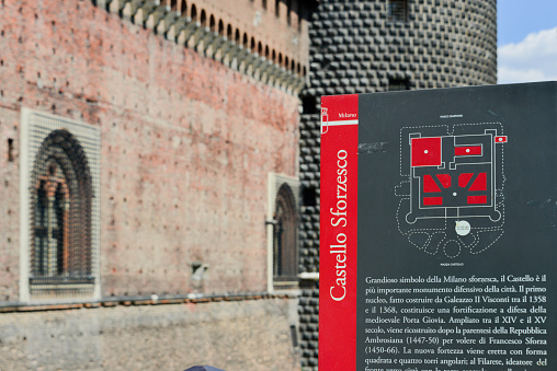 A sign explains the significance of the massive walls and moat of the Sforza Castle, a citadel, and home of the powerful Sforza family of Milan. Today it is a museum and art galley and is a major tourist attraction.