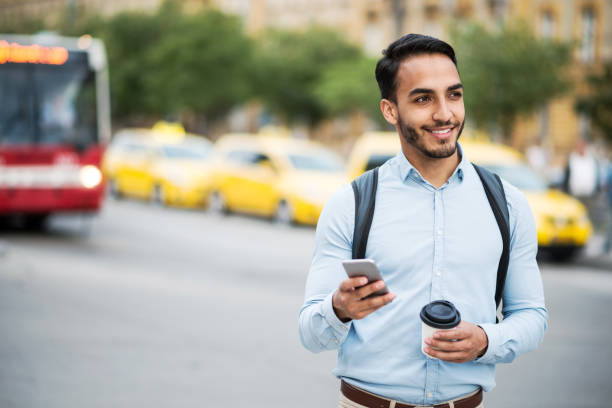 istock Latino man using mobile app to call crowd-sourced taxi 858726002