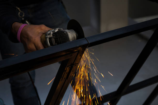 istock Close-up of worker cutting metal with grinder. Sparks while grinding iron. 858727292