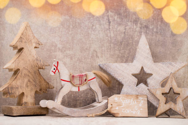 istock Christmas tree decorations on a wooden background. With bokeh ornaments. 858734720