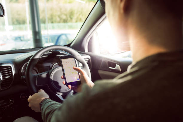istock Midsection of man using smartphone in car 858751916