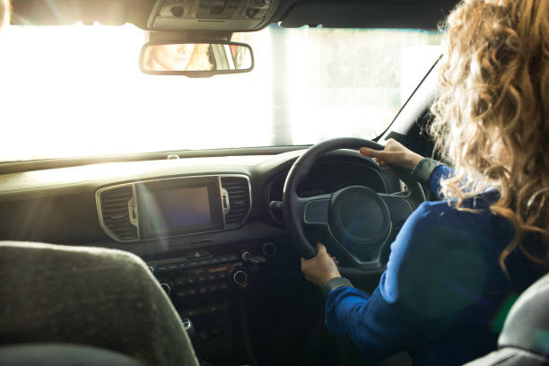istock Woman test driving at showroom 858752804