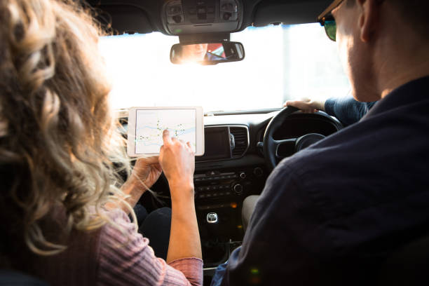 istock Rear view of woman showing tablet computer to man 858753014