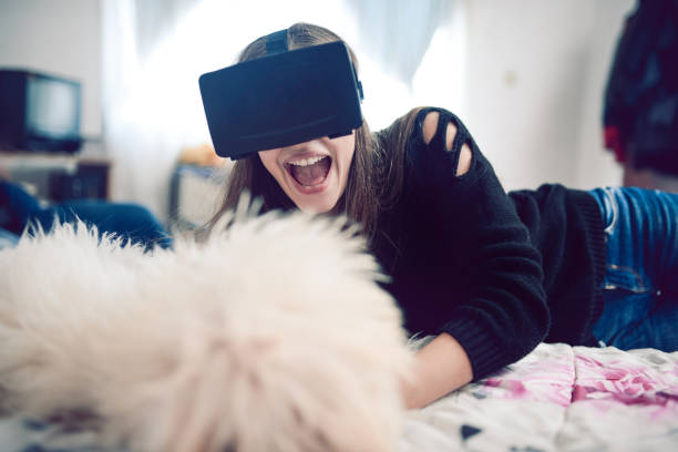 istock Cute Girl Playing with VR at Home With Pet Dog 858755984