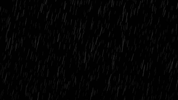 Falling raindrops on black background, black and white luminance matte stock photo
