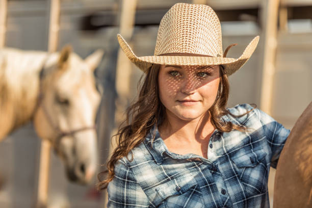 istock Cowgirl Brushing Horse on Authentic Ranch 858763278