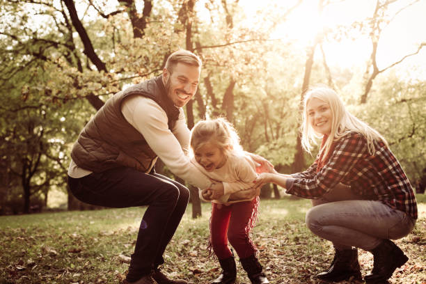 istock Parents with daughter in meadow. 858766110