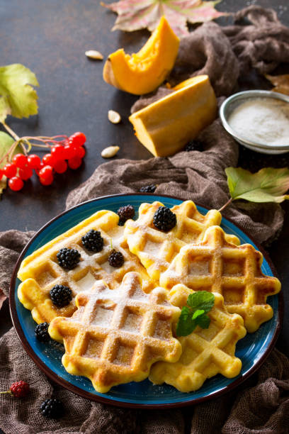 Breakfast table with pumpkin waffles and fresh blackberries on a stone or slate background. Breakfast table with pumpkin waffles and fresh blackberries on a stone or slate background. 7944 stock pictures, royalty-free photos & images