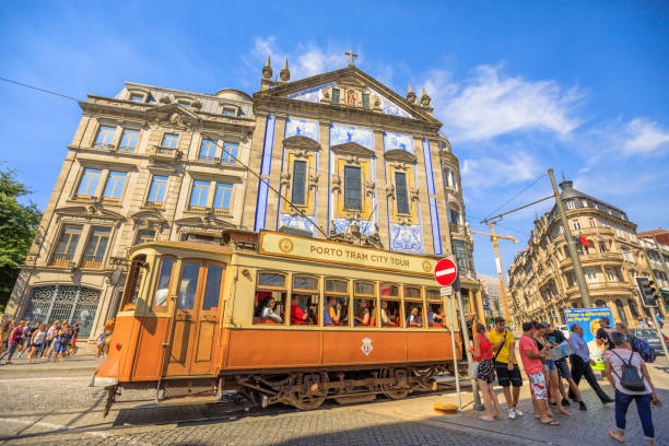 Porto, Portugal - August 11, 2017: Porto Tram City Tour and people in front of Azulejo facade of Saint Anthony's Church Congregados, Almeida Garrett square, Porto historic center