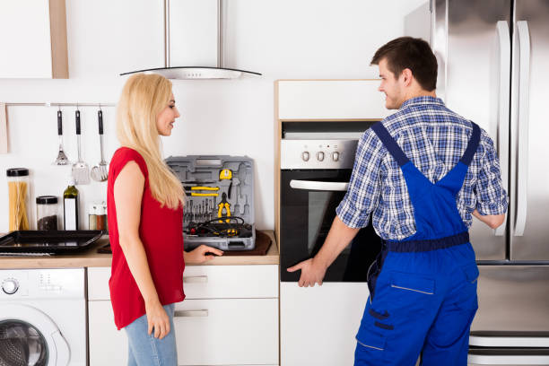 istock Male Worker Installing Oven For Repairing In Kitchen 858767144