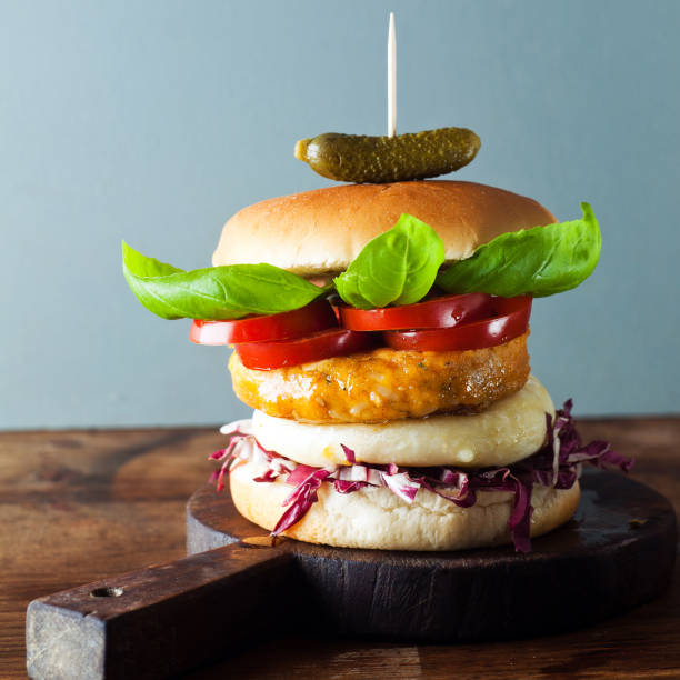 istock Fresh burger closeup on cutting board . on wooden table. 858776342