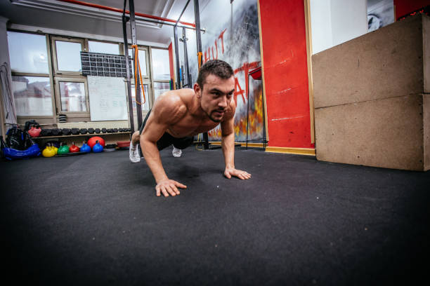 istock Bodybuilder doing push-ups in the gym 858777174