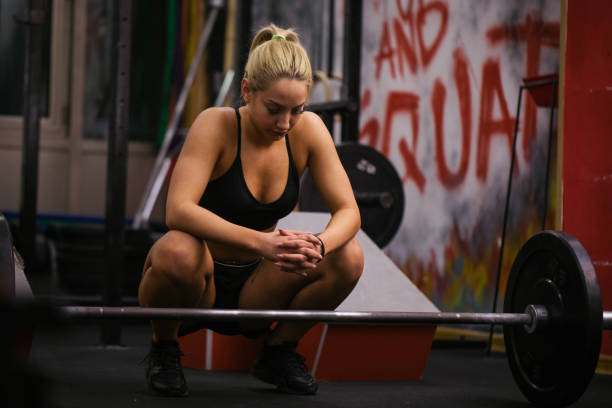 istock Woman resting after lifting weights 858778118
