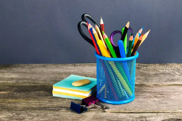 Pencil-box and school equipment on table. Back to school.
