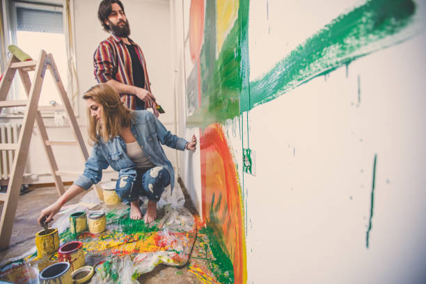 istock Painting walls together 858783776