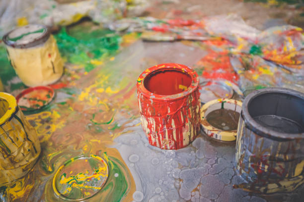 Open paint cans on the floor after painting