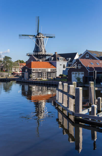 istock Historic windmill with reflection in the water in Haarlem, Netherlands 858787198