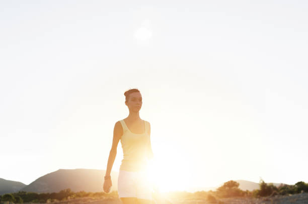Handsome imagined woman walking and making memories of her amazing adventure on sunset. Portrait of beautiful girl with space for text