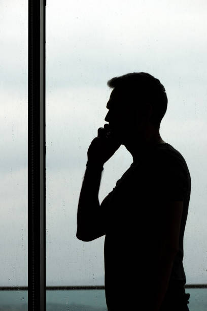istock Silhouette of man using phone 858787414