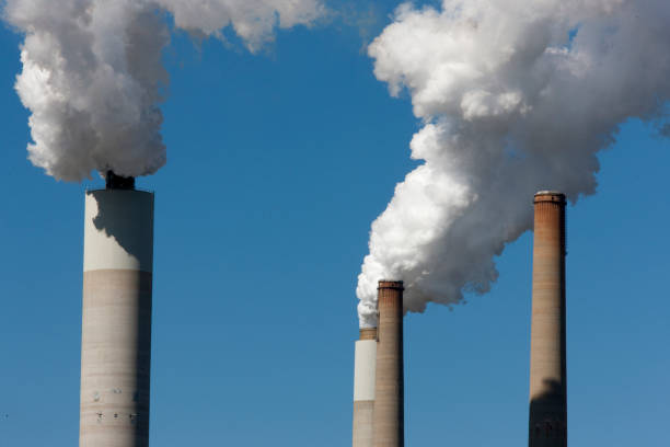 istock Smoke stacks at a power plant 858787608
