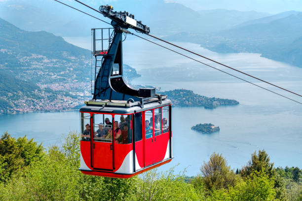 Lago Maggiore (Lake Maggiore) cableway cabin go downhill from the mount Mottarone top (Stresa, Italy, May 22 2017) Lago Maggiore (Lake Maggiore) cableway cabin go downhill from the mount Mottarone top (Stresa, Italy, May 22 2017) italian lake district photos stock pictures, royalty-free photos & images