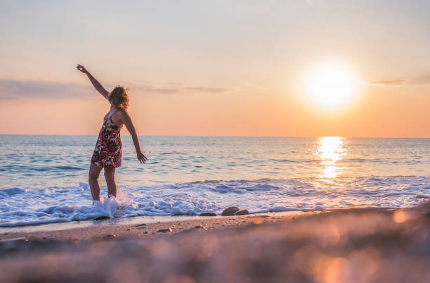 istock Playfull woman at the beach 858790700