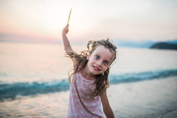 Preschool aged girl playing on the summer evening