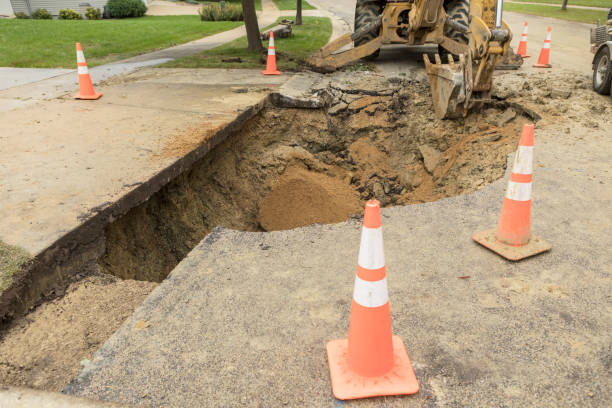 istock Large Hole in Residential Street from Broken Water Main 858790844
