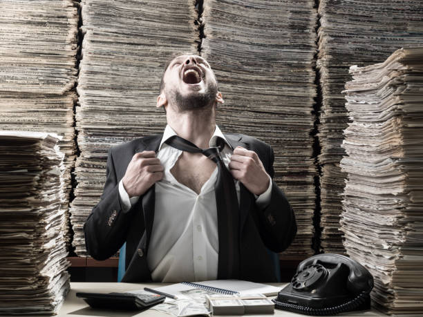 istock Office Worker Screaming Out While Surrounded By Large Amount Of Documents and Files 858797466