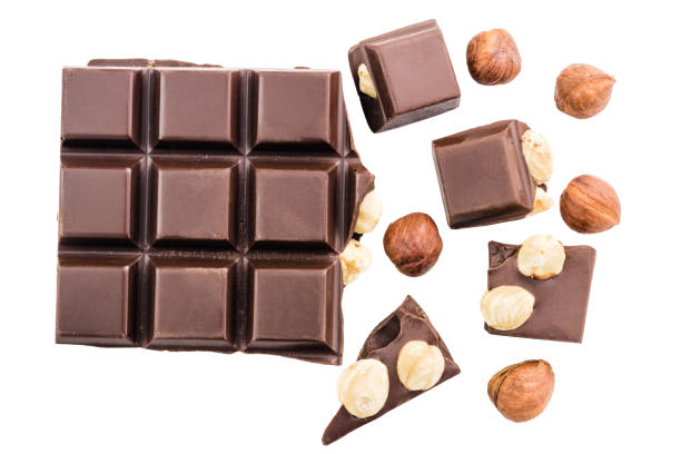 istock Pieces of bitter dark chocolate cubes with hazelnut isolated on white background, top view 858801020