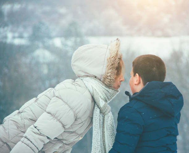 istock mother and son having a fun on the snow 858801928