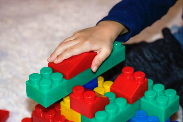 istock Close up of child playing with toy blocks. 858802032