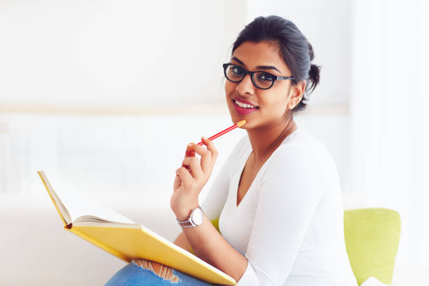 beautiful young indian girl, student with book, studying
