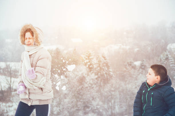 istock mother and son having a fun on the snow 858806970